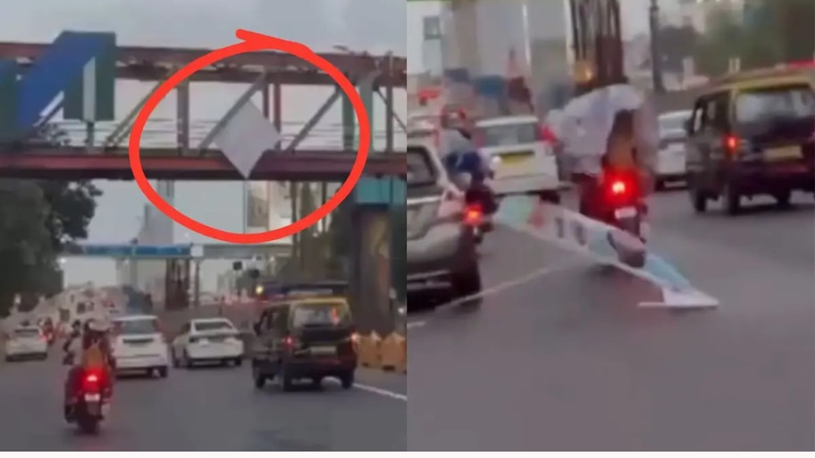 सड़क पर काल बनकर गिरा विशालकाय बर्थडे बैनर! हाईवे पर बाल-बाल बचा बाइक सवार कपल, देखें रोंगटे खड़े करने वाला VIDEO